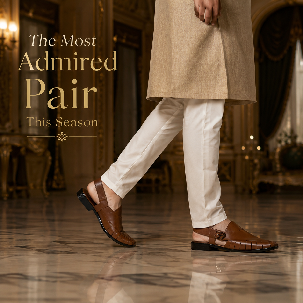 Person wearing a beige coat and white pants with brown shoes in an elegant indoor setting.